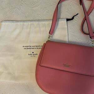 Brand new. Never used. Light pink. Lock clasp. Kate Spade purse.
